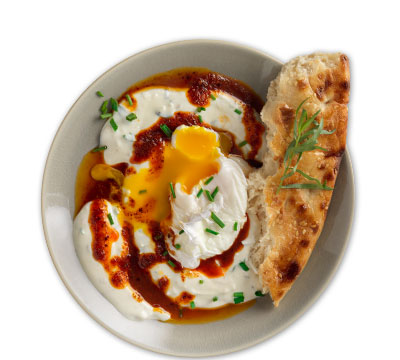 Poached eggs on spiced yogurt with aleppo and barbari bread
