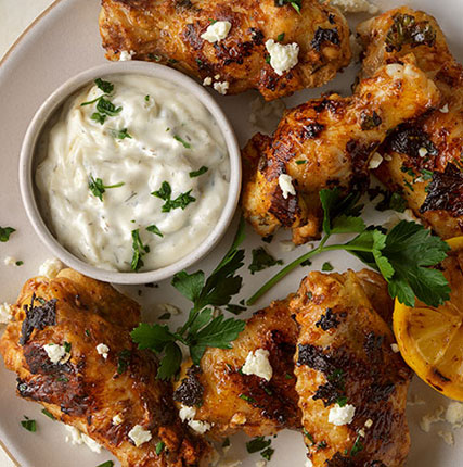 Yogurt-Marinated Grilled Chicken Wings with Tzatziki Sauce and Charred Lemons