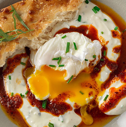 Poached Eggs on Spiced Yogurt with Aleppo Chili Drizzle and Barbari Bread